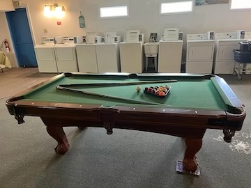 Windswept RV Park lounge — pool table, TV and laundry area